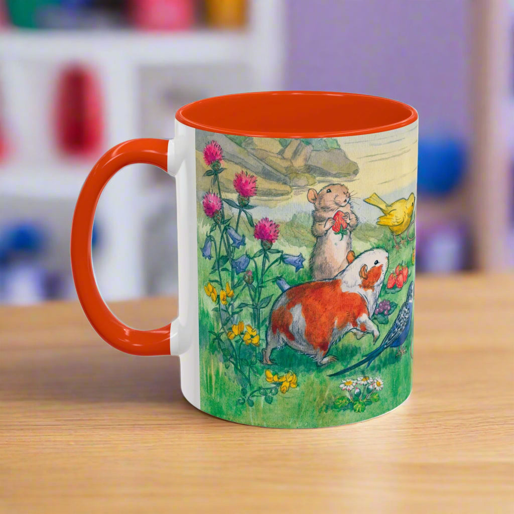 orange Mug with a colorful design of woodland animals guinea pigs and flowers