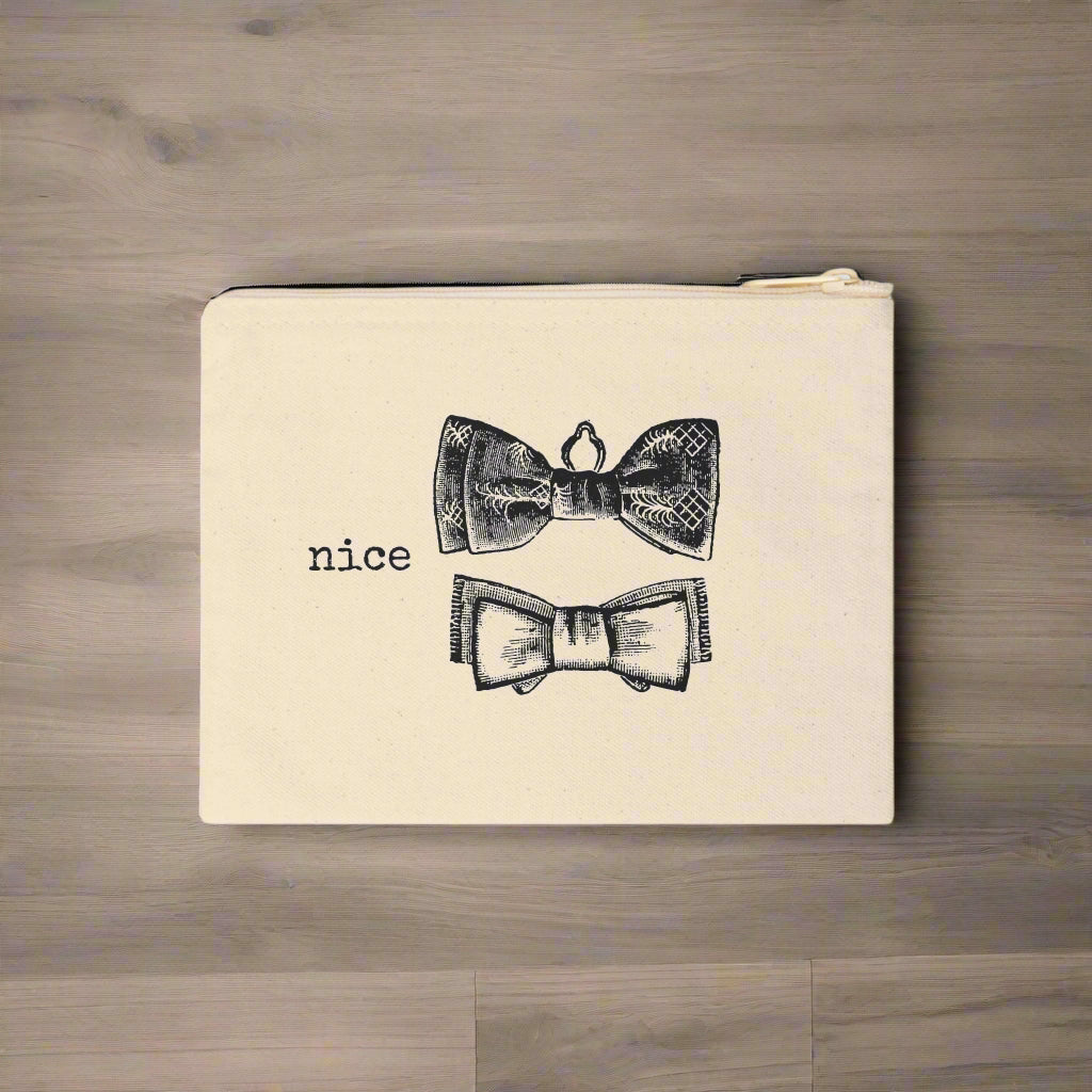 Beige pouch with black bow tie designs and the word 'nice' on a white background