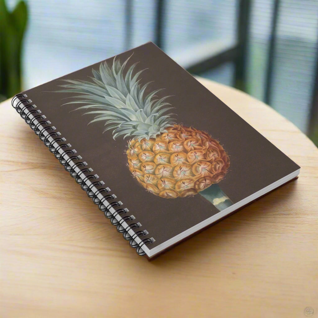 Spiral-bound notebook with a pineapple design on a brown background