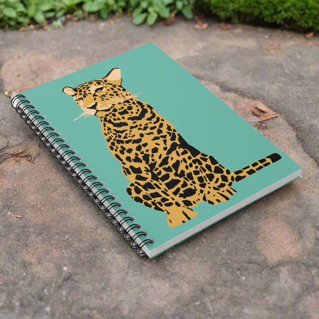 Notebook with a leopard illustration on a teal background