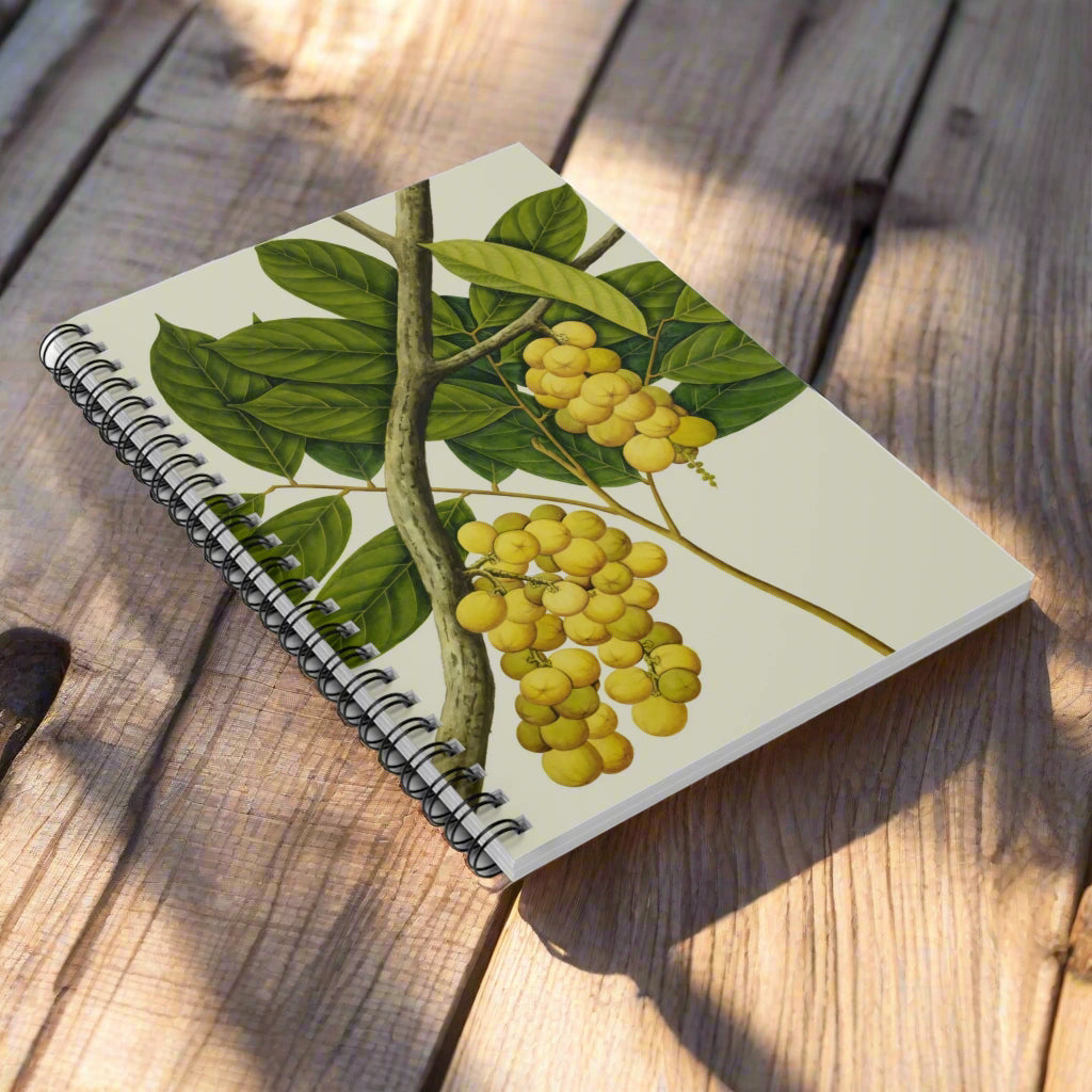Notebook with a botanical design of yellow fruits and green leaves on a white background